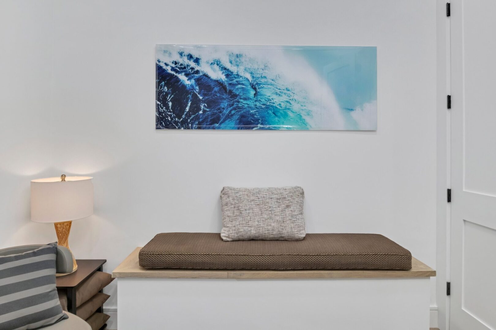 A large picture of the ocean hanging on the wall.