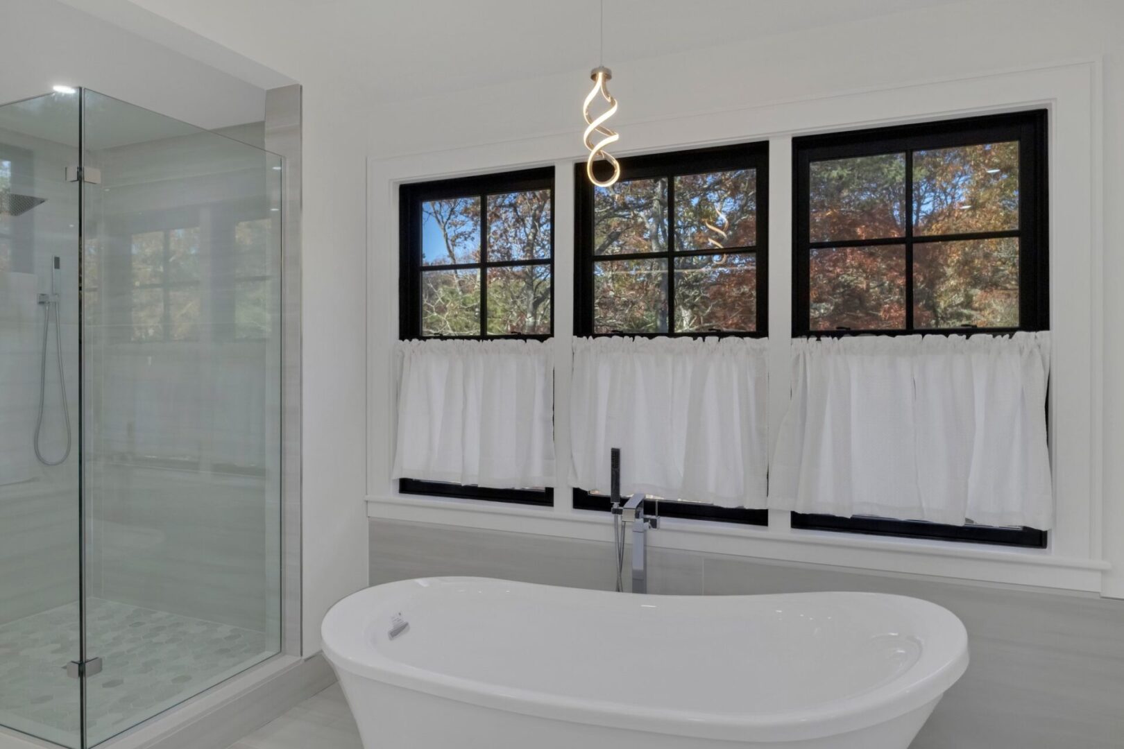A bathroom with a tub, shower and window.