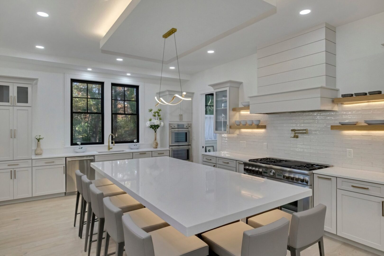 A large white table in the middle of a kitchen.